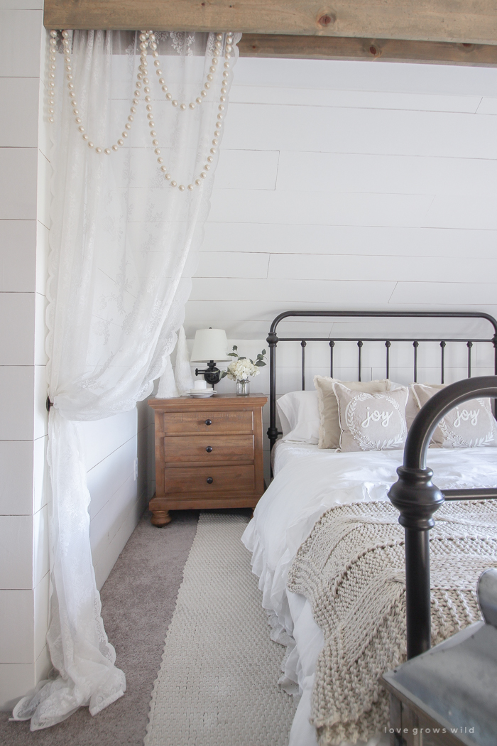 This cozy master bedroom is beautifully decorated for Christmas with soft neutrals and tons of farmhouse charm. 