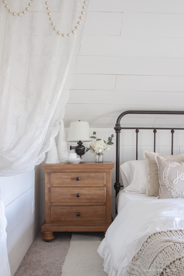 This cozy master bedroom is beautifully decorated for Christmas with soft neutrals and tons of farmhouse charm. 