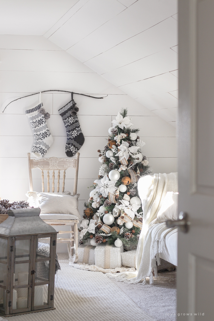 This cozy master bedroom is beautifully decorated for Christmas with soft neutrals and tons of farmhouse charm. 