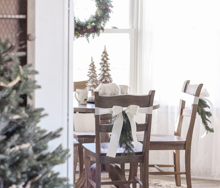 Step inside this beautiful farmhouse and discover a winter wonderland themed kitchen decorated for Christmas with simple touches of greenery and winter charm!