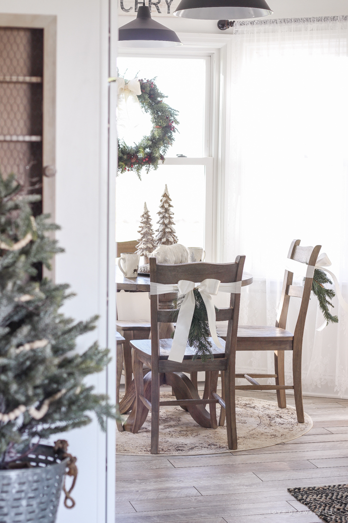 Step inside this beautiful farmhouse and discover a winter wonderland themed kitchen decorated for Christmas with simple touches of greenery and winter charm!