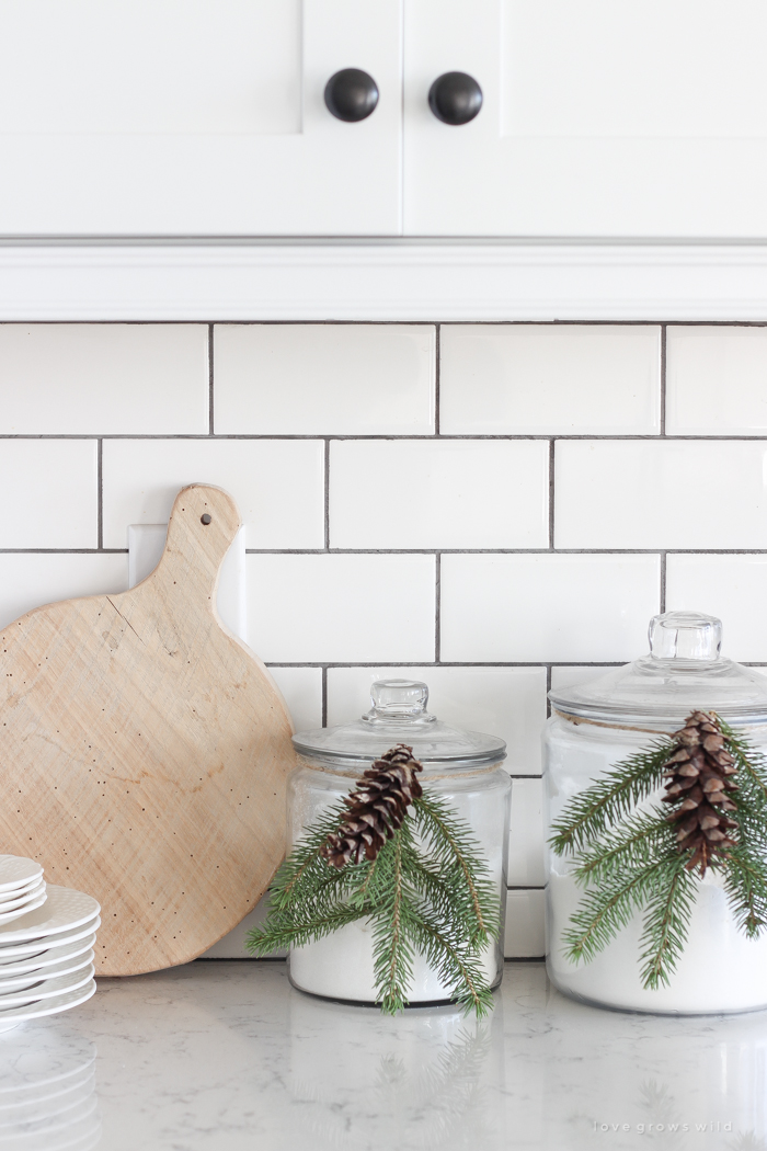 Step inside this beautiful farmhouse and discover a winter wonderland themed kitchen decorated for Christmas with simple touches of greenery and winter charm!