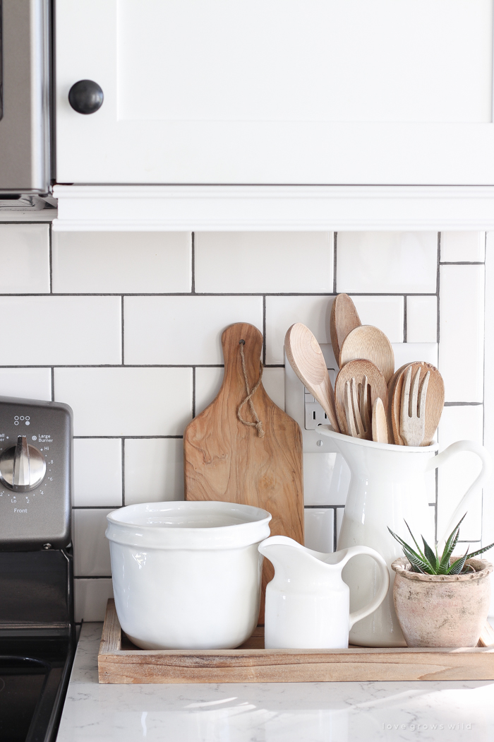 Step inside this beautiful farmhouse and discover a winter wonderland themed kitchen decorated for Christmas with simple touches of greenery and winter charm!