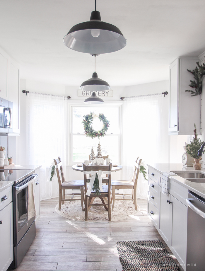 Step inside this beautiful farmhouse and discover a winter wonderland themed kitchen decorated for Christmas with simple touches of greenery and winter charm!