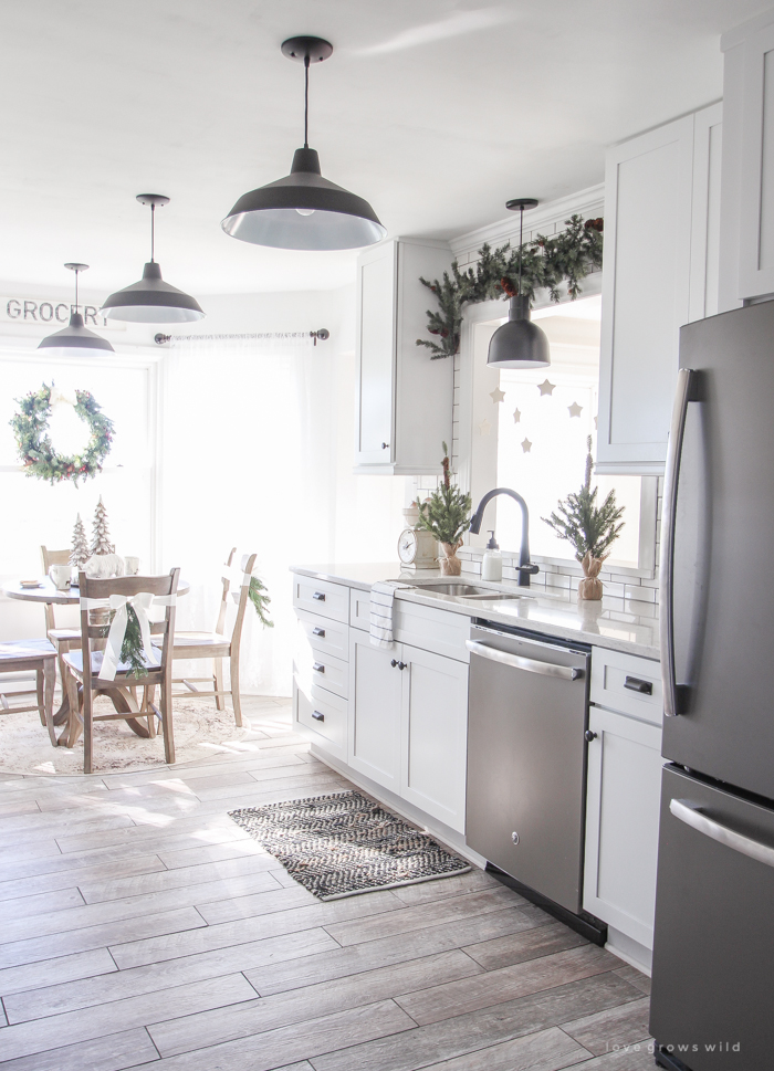 Step inside this beautiful farmhouse and discover a winter wonderland themed kitchen decorated for Christmas with simple touches of greenery and winter charm!