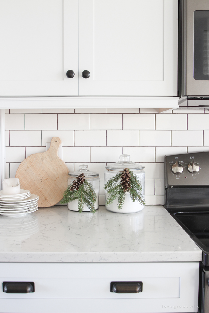 Step inside this beautiful farmhouse and discover a winter wonderland themed kitchen decorated for Christmas with simple touches of greenery and winter charm!