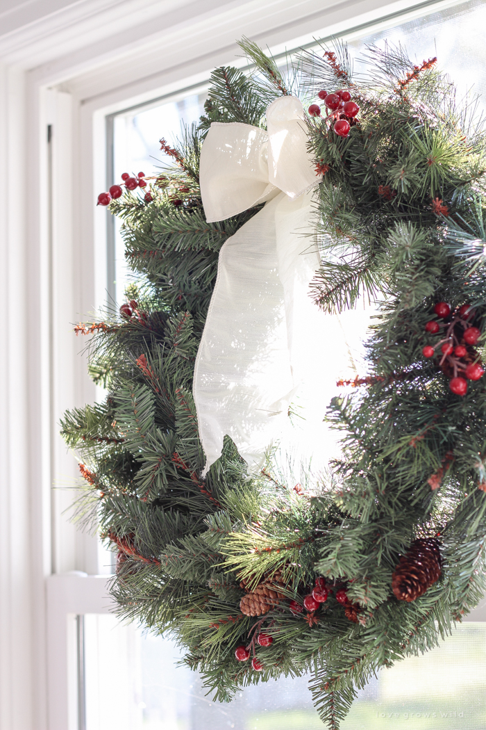 Step inside this beautiful farmhouse and discover a winter wonderland themed kitchen decorated for Christmas with simple touches of greenery and winter charm!