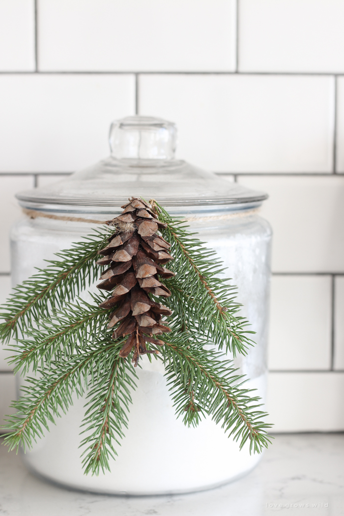 Step inside this beautiful farmhouse and discover a winter wonderland themed kitchen decorated for Christmas with simple touches of greenery and winter charm!