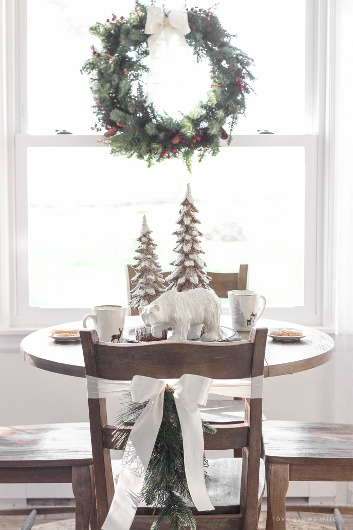 Step inside this beautiful farmhouse and discover a winter wonderland themed kitchen decorated for Christmas with simple touches of greenery and winter charm!