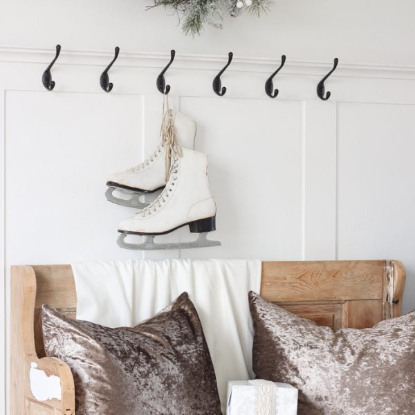 A simple winter white entryway decorated for the holidays in a beautiful farmhouse