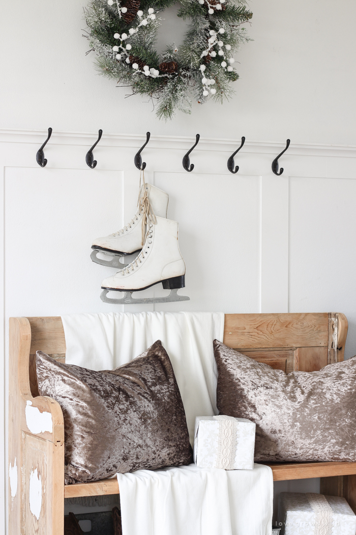 A simple winter white entryway decorated for the holidays in a beautiful farmhouse