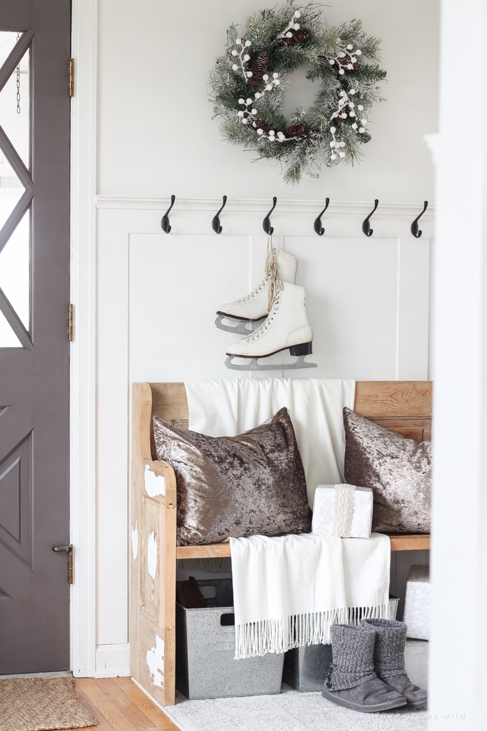 A simple winter white entryway decorated for the holidays in a beautiful farmhouse