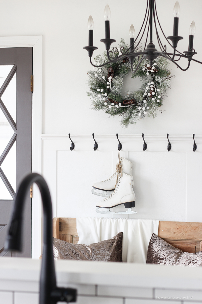 A simple winter white entryway decorated for the holidays in a beautiful farmhouse