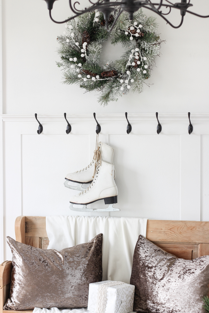 A simple winter white entryway decorated for the holidays in a beautiful farmhouse