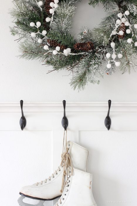 A simple winter white entryway decorated for the holidays in a beautiful farmhouse