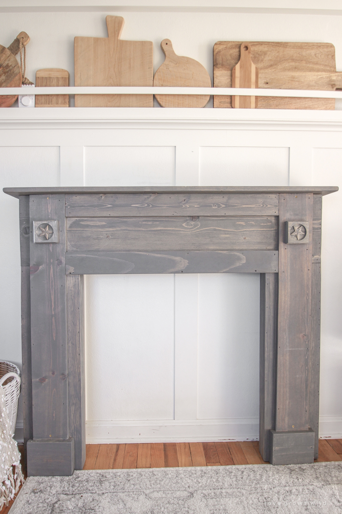 A rustic mantel is given a big makeover for the holidays! See how milk paint transformed this cozy cottage mantel.