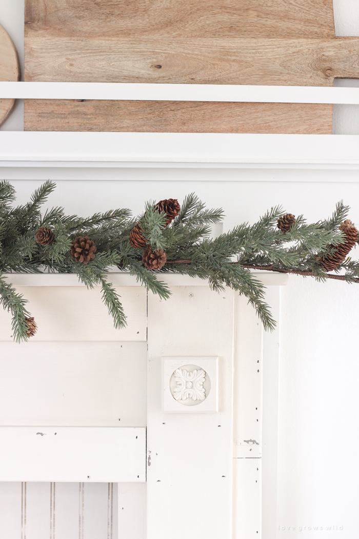 A rustic mantel is given a big makeover for the holidays! See how milk paint transformed this cozy cottage mantel.