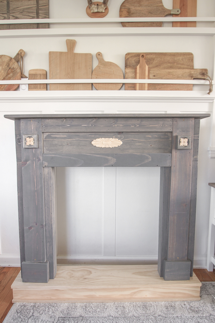 A rustic mantel is given a big makeover for the holidays! See how milk paint transformed this cozy cottage mantel.