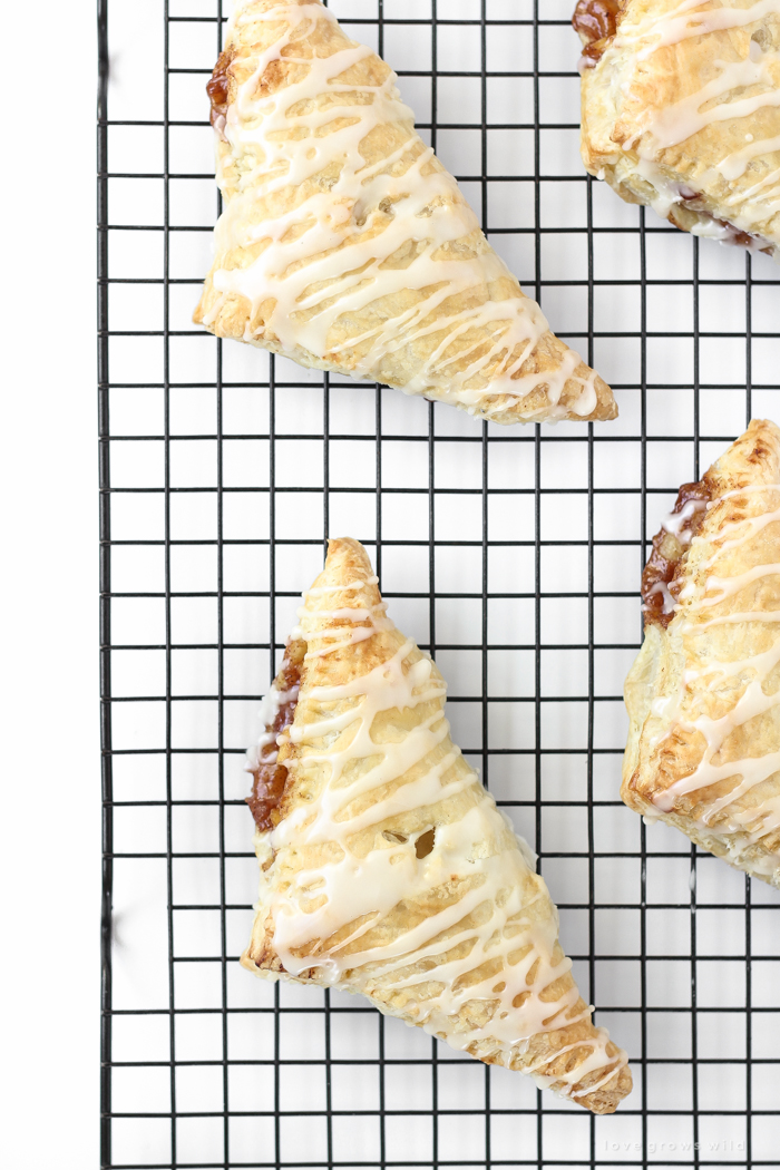 Delicious apple turnovers with a flaky pastry crust, apple cinnamon filling, and sweet vanilla glaze