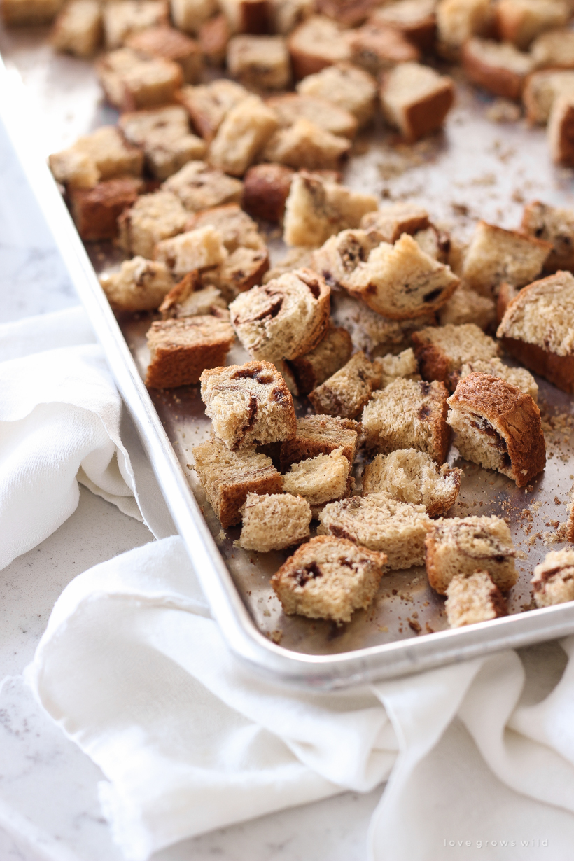 Warm pumpkin bread pudding fresh out of the oven served a la mode with a drizzle of salted caramel and chopped pecans sprinkled on top. Get the recipe at LoveGrowsWild.com