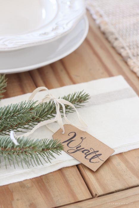 A simple, no fuss Christmas tablescape with fresh greens and beautiful antique metal accents