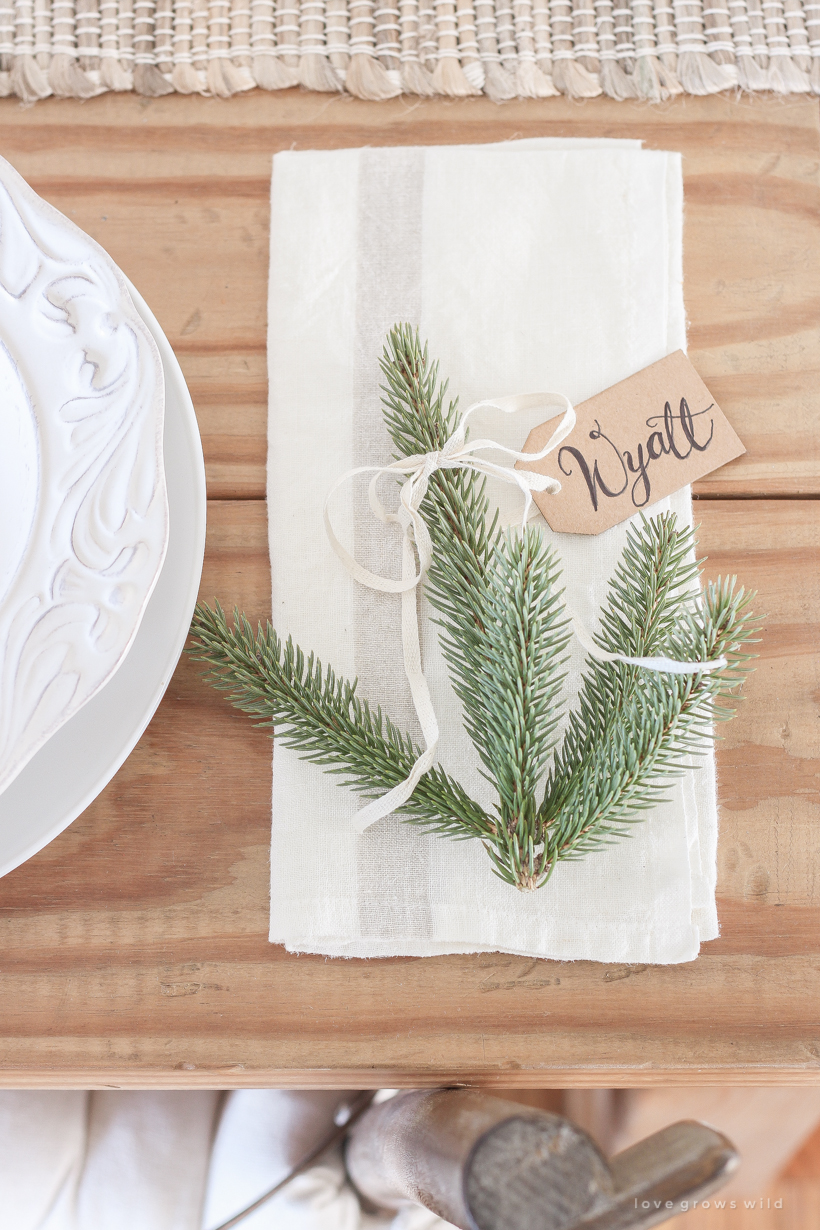 A simple, no fuss Christmas tablescape with fresh greens and beautiful antique metal accents