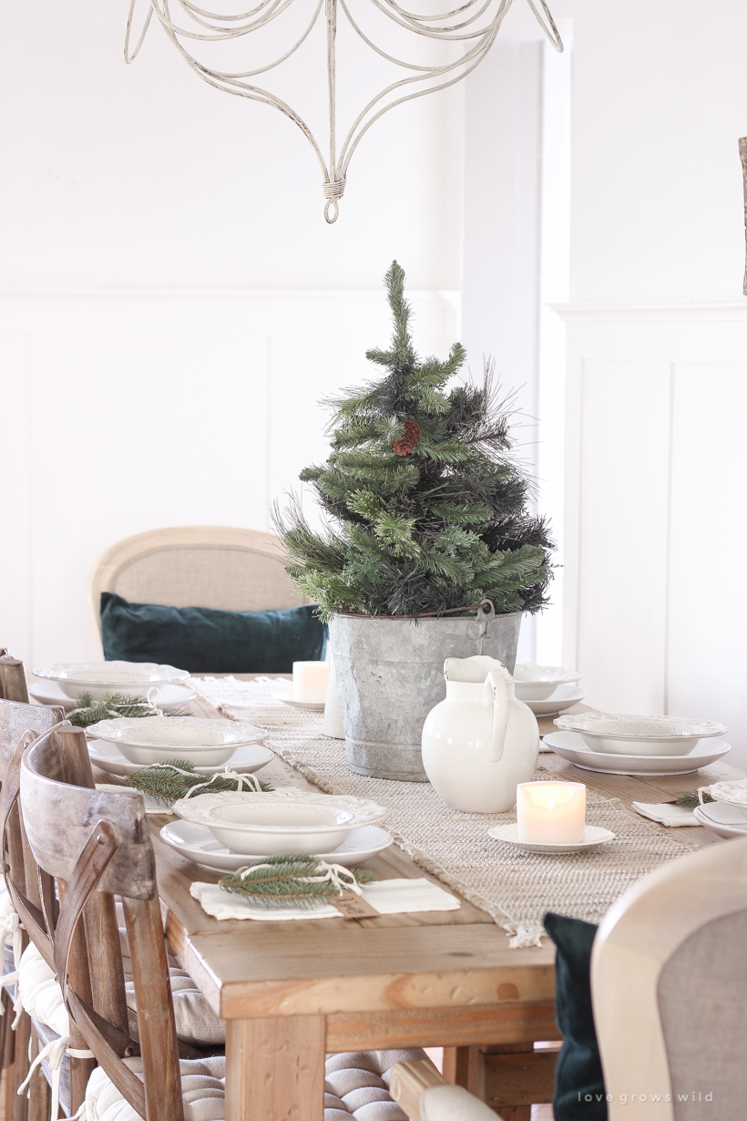 A simple, no fuss Christmas tablescape with fresh greens and beautiful antique metal accents