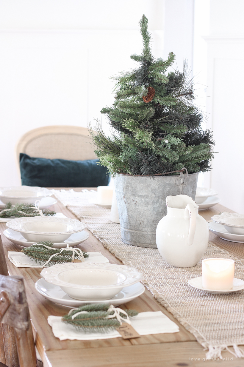 A simple, no fuss Christmas tablescape with fresh greens and beautiful antique metal accents