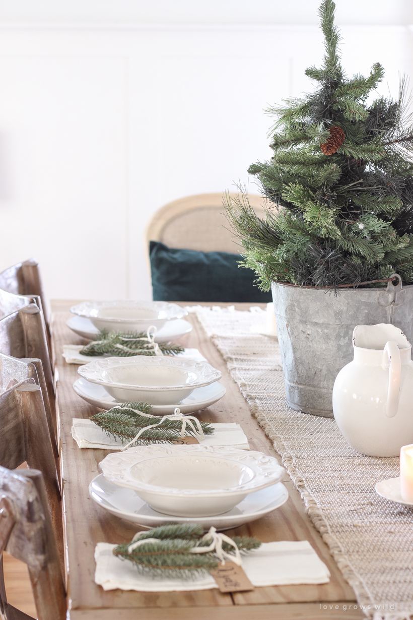 A simple, no fuss Christmas tablescape with fresh greens and beautiful antique metal accents