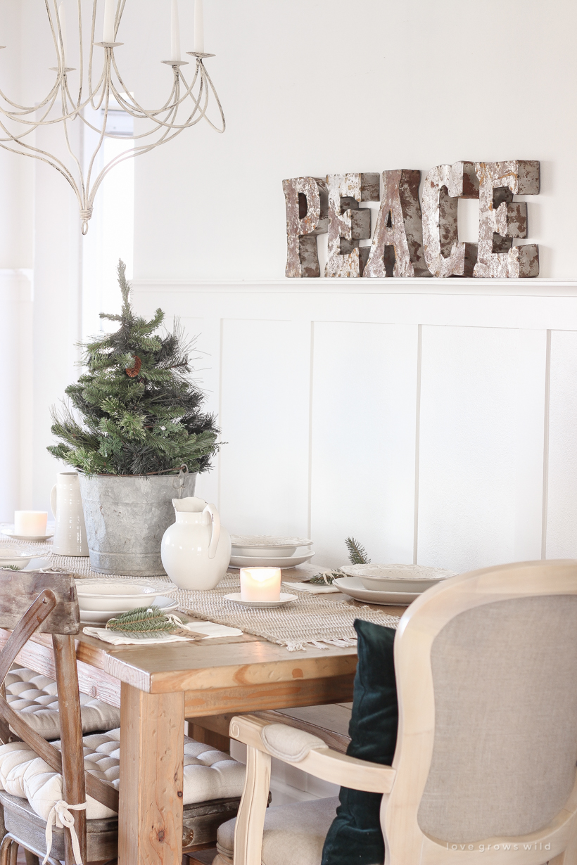 A simple, no fuss Christmas tablescape with fresh greens and beautiful antique metal accents