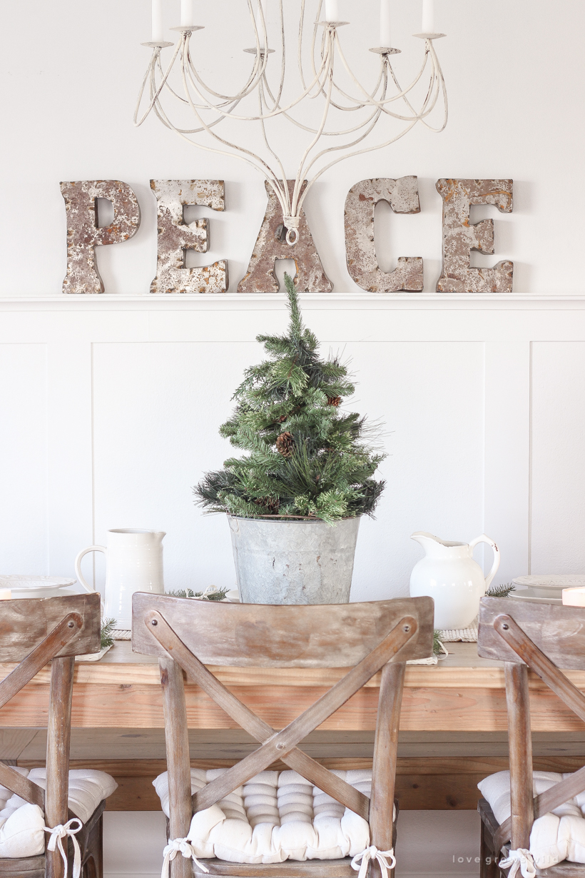 A simple, no fuss Christmas tablescape with fresh greens and beautiful antique metal accents