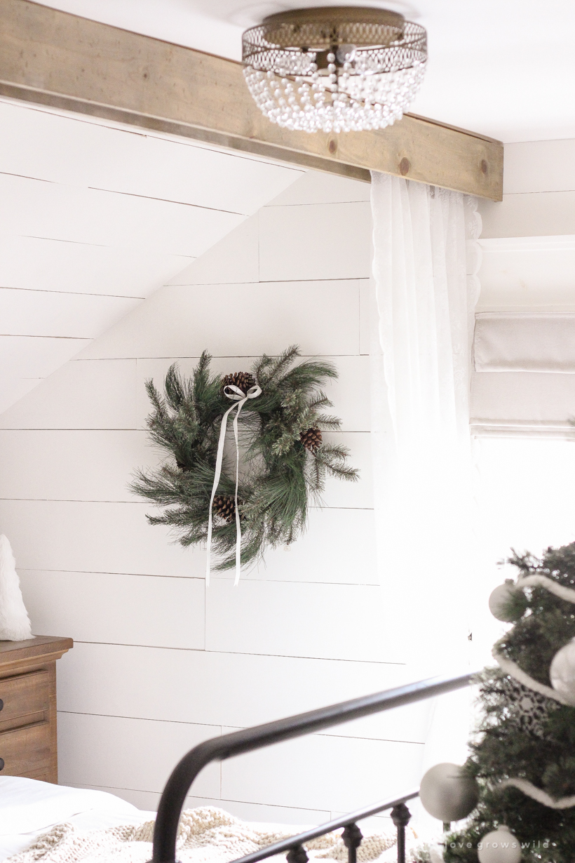 A simple, cozy bedroom decorated for Christmas with a "vintage winter wonderland" theme