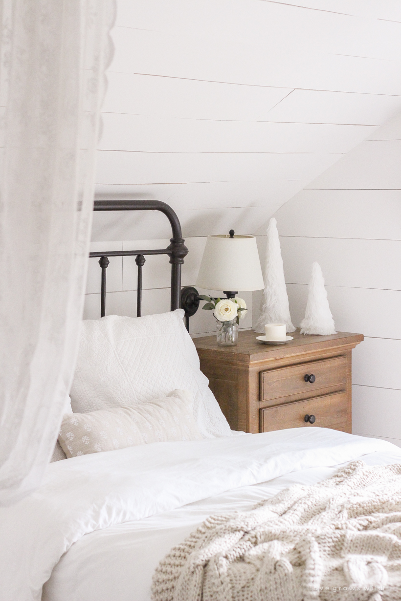 A simple, cozy bedroom decorated for Christmas with a "vintage winter wonderland" theme