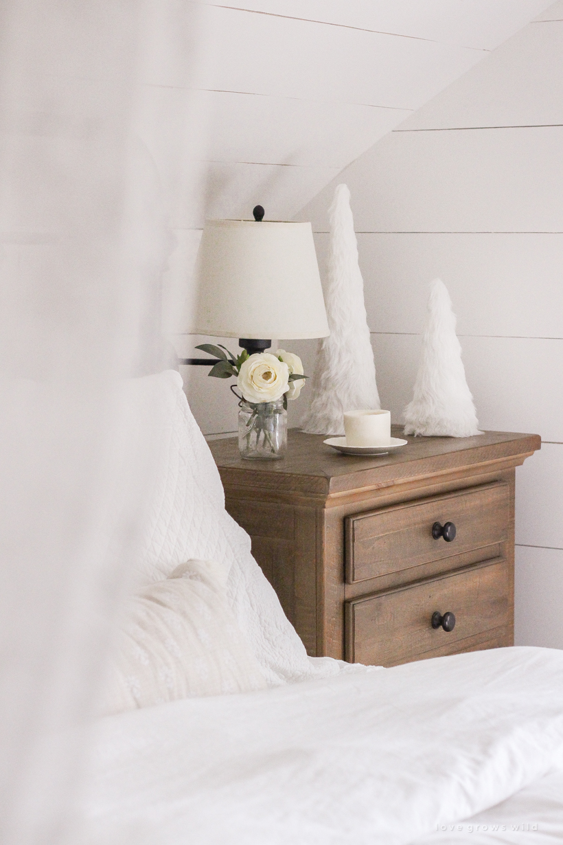 A simple, cozy bedroom decorated for Christmas with a "vintage winter wonderland" theme