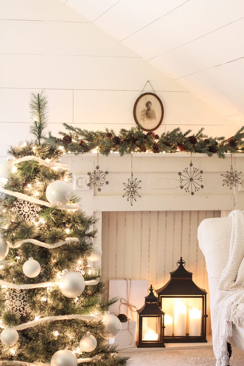 A beautiful farmhouse glowing with Christmas lights at night