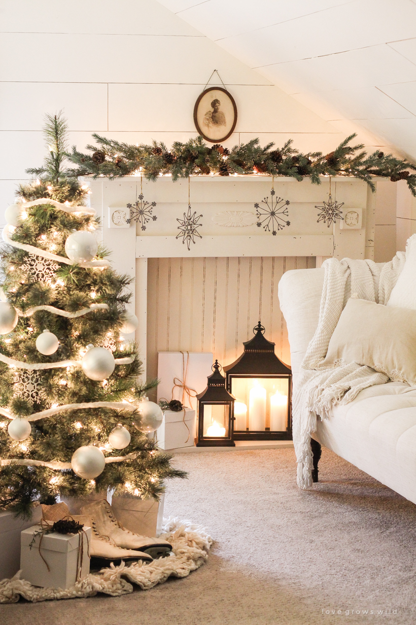 A beautiful farmhouse glowing with Christmas lights at night