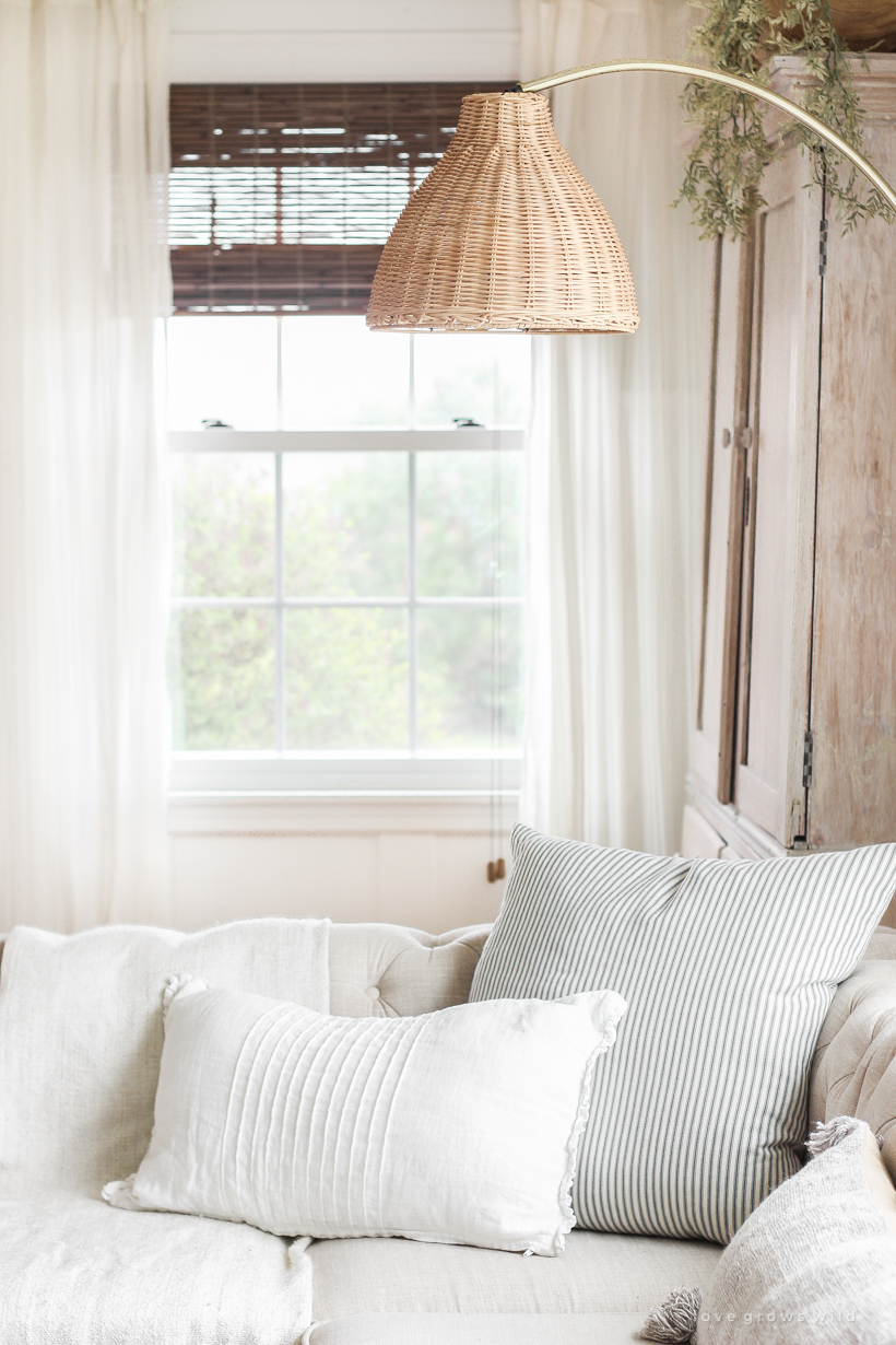 A gorgeous antique brass and rattan floor lamp is the perfect accessory in this neutral living room. See more details in this blog post!