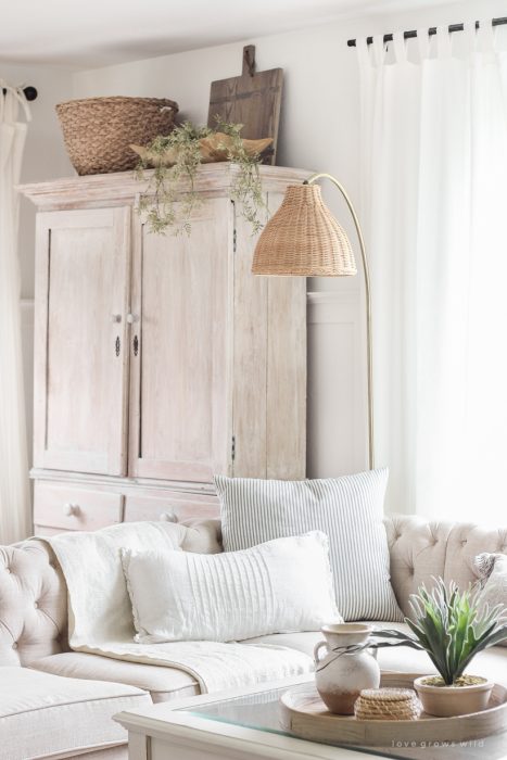 A gorgeous antique brass and rattan floor lamp is the perfect accessory in this neutral living room. See more details in this blog post!