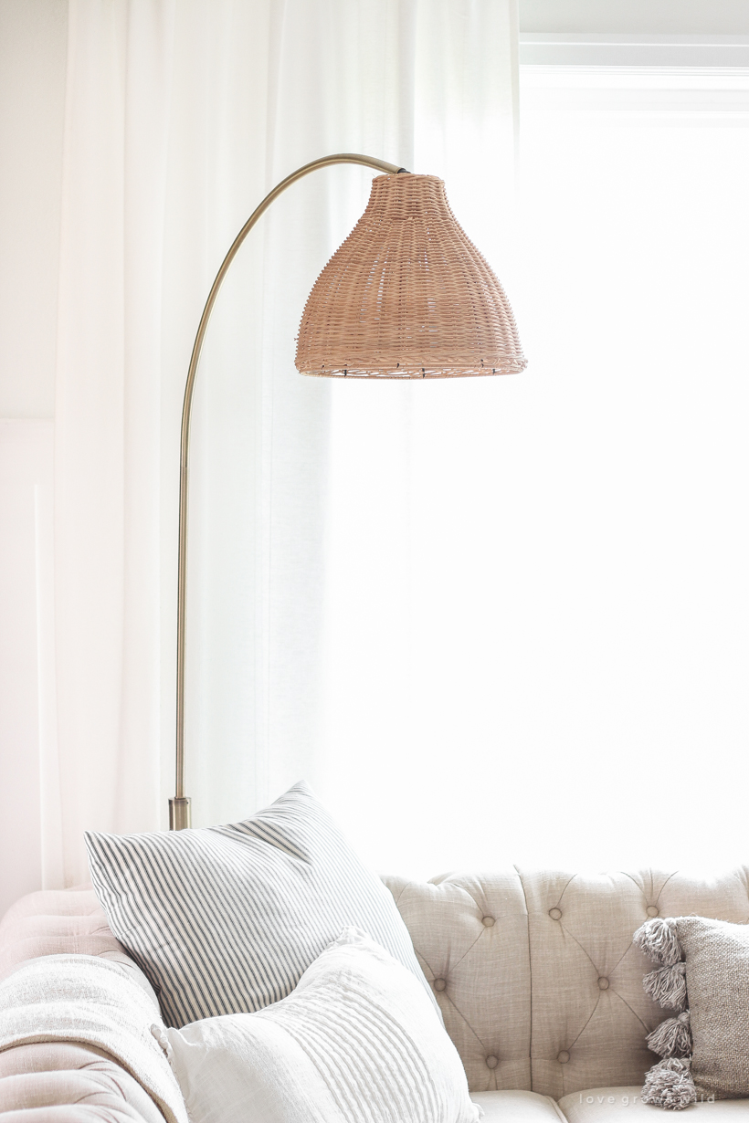 A gorgeous antique brass and rattan floor lamp is the perfect accessory in this neutral living room. See more details in this blog post!