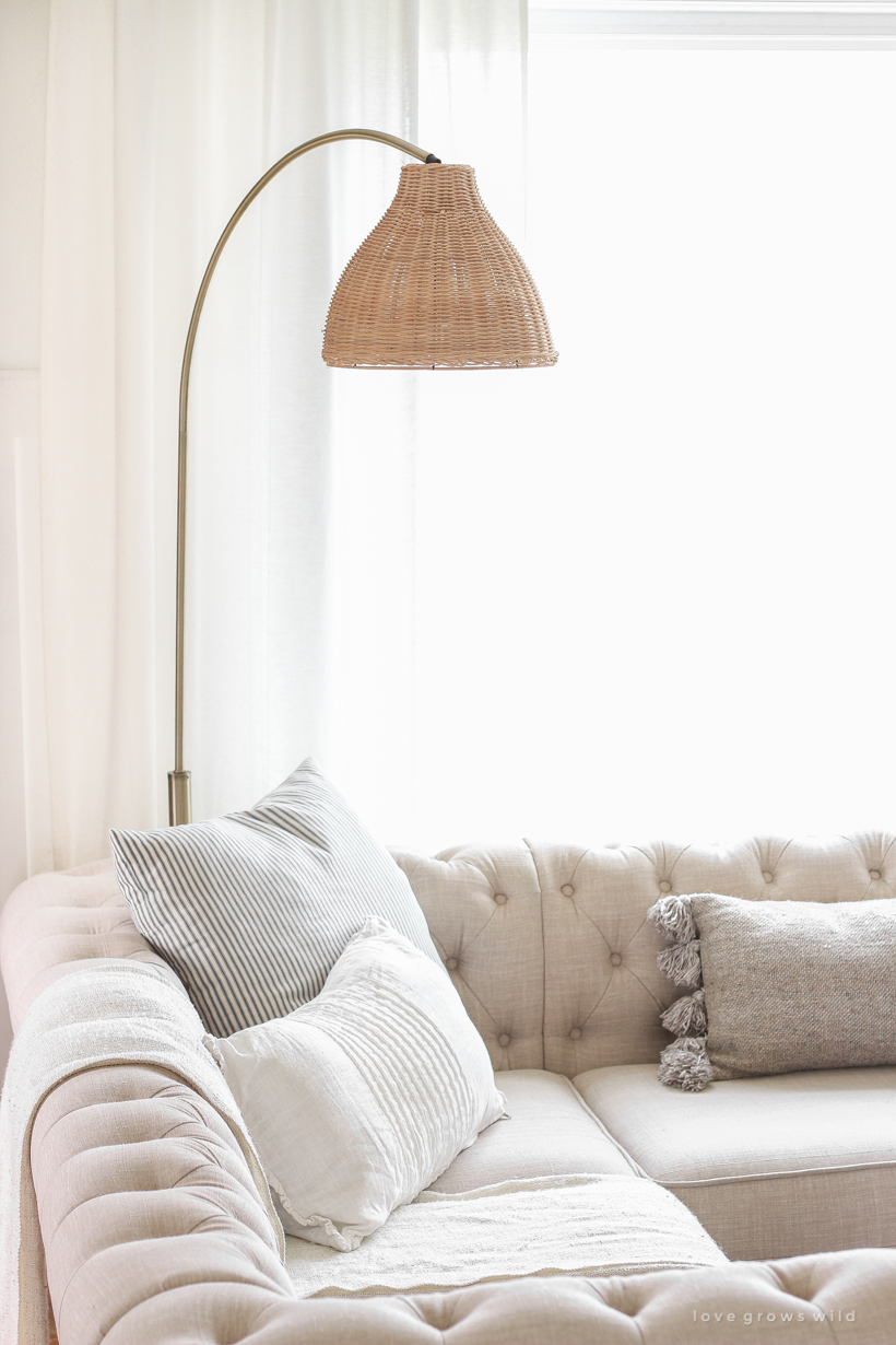 A gorgeous antique brass and rattan floor lamp is the perfect accessory in this neutral living room. See more details in this blog post!