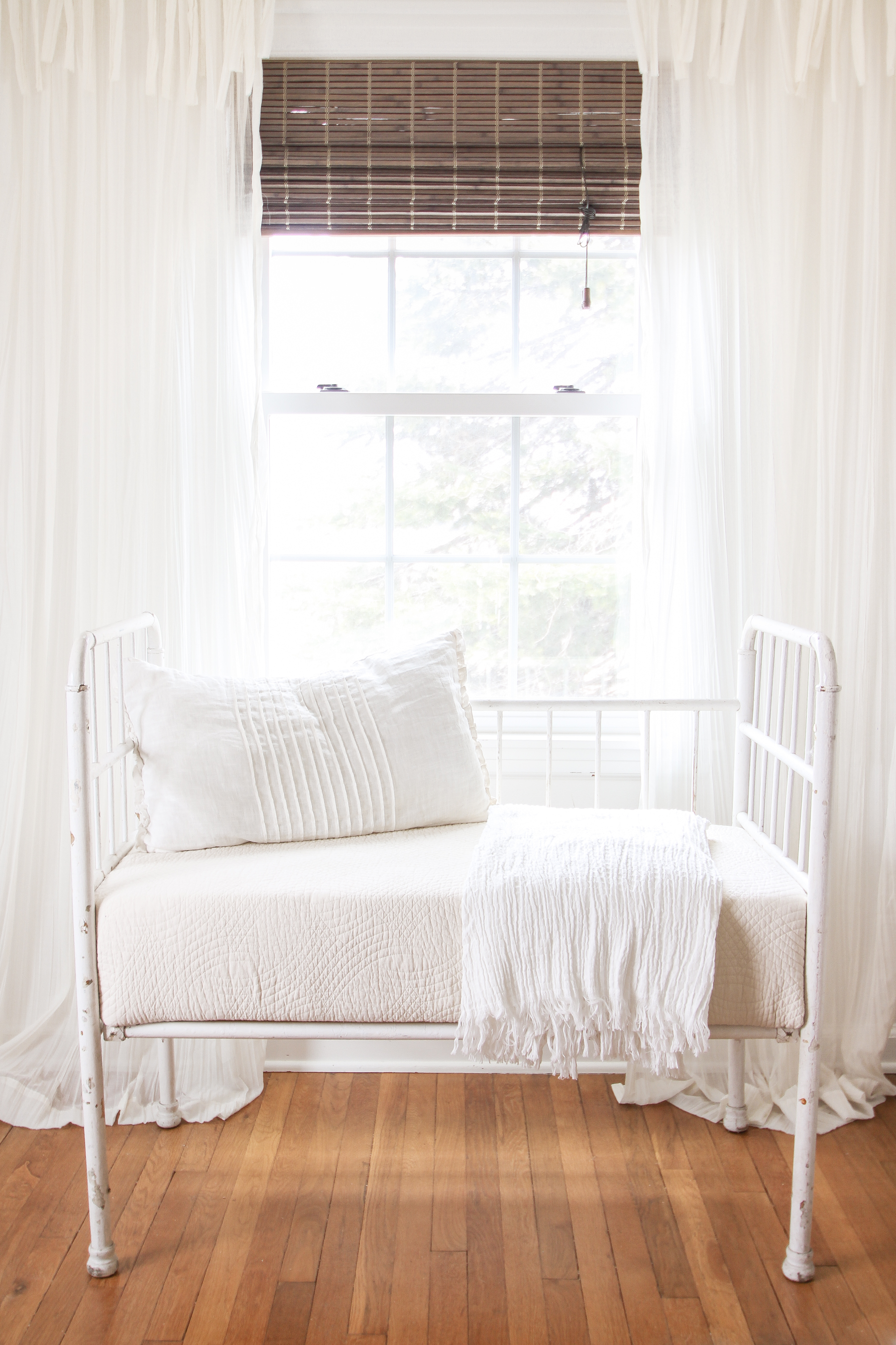 Home and lifestyle blogger Liz Fourez turns a wooden antique crib into an adorable bench with a quilted cushion. 