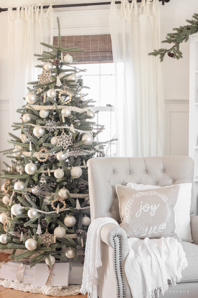 A peek inside home blogger Liz Fourez's farmhouse living room all decorated for Christmas