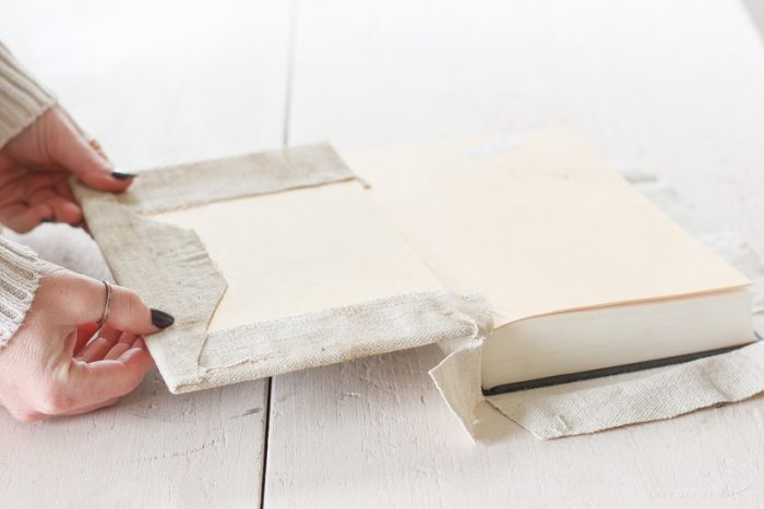 How to cover books in a beautifully distressed canvas fabric to use for styling shelves and tables.