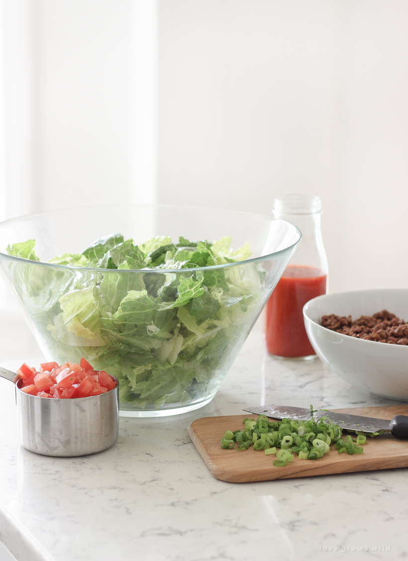 A delicious taco salad made with fresh produce, flavorful seasoned beef, crunchy Dorito chips and a special tangy dressing! This party favorite is fast, fresh, delicious, and always a crowd-pleaser!