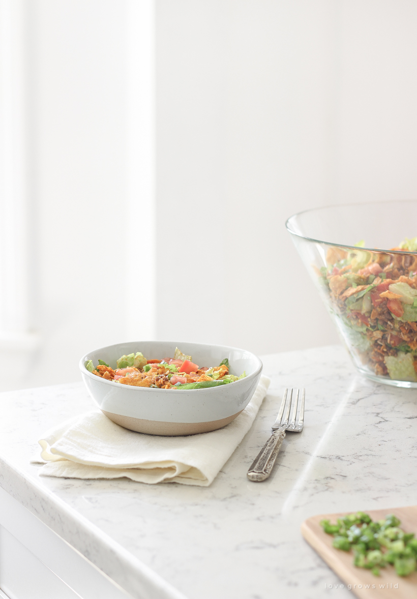 A delicious taco salad made with fresh produce, flavorful seasoned beef, crunchy Dorito chips and a special tangy dressing! This party favorite is fast, fresh, delicious, and always a crowd-pleaser!