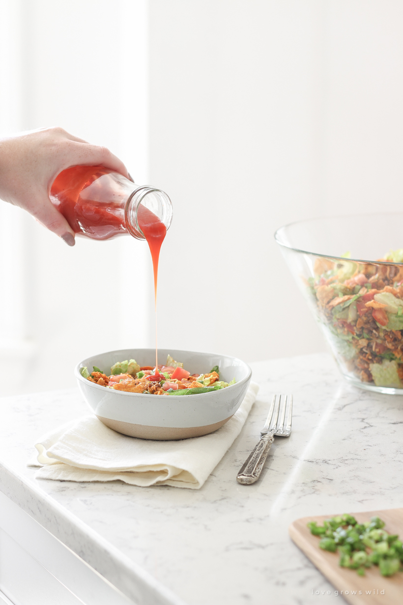 A delicious taco salad made with fresh produce, flavorful seasoned beef, crunchy Dorito chips and a special tangy dressing! This party favorite is fast, fresh, delicious, and always a crowd-pleaser!