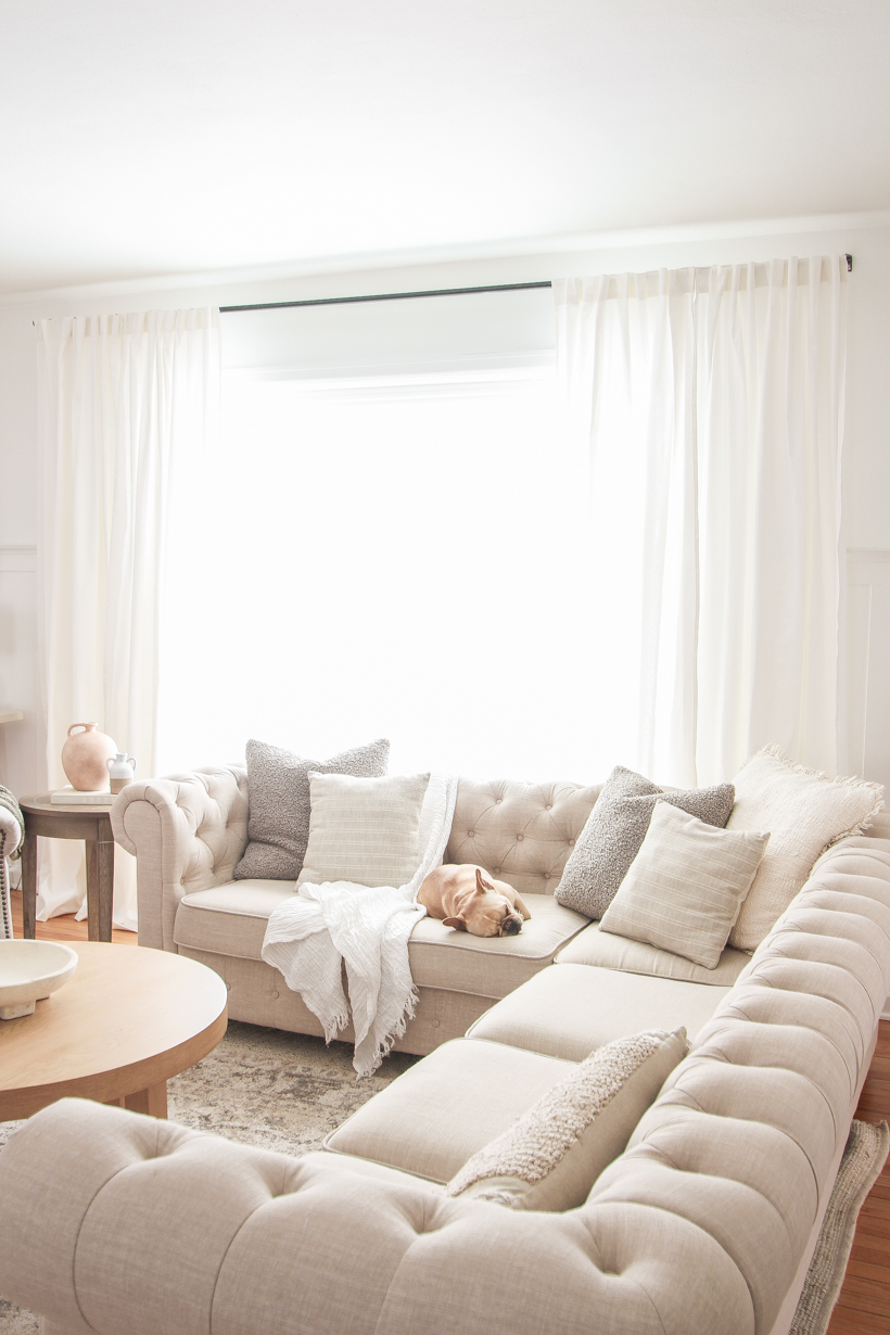 The best way to hang curtains to make your windows appear larger and more luxurious! See tips from home blogger and interior decorator Liz Fourez of LoveGrowsWild.com