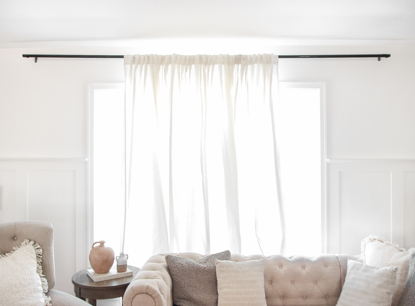 The best way to hang curtains to make your windows appear larger and more luxurious! See tips from home blogger and interior decorator Liz Fourez of LoveGrowsWild.com