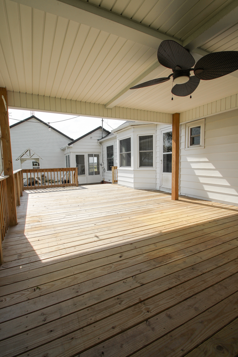 Interior decorator and home blogger Liz Fourez shares everything you need to know about staining a deck from prep to finish!