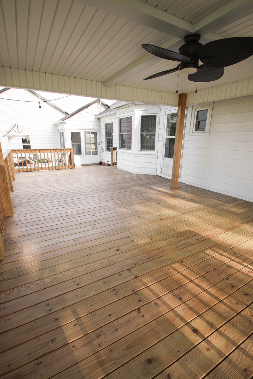 Interior decorator and home blogger Liz Fourez shares everything you need to know about staining a deck from prep to finish!